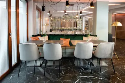 a dining room with a table and six chairs at Leonardo Boutique Hotel Krakow City Center in Kraków