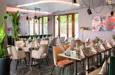 a restaurant with a long table and chairs at Leonardo Boutique Hotel Krakow City Center in Kraków
