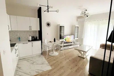 a kitchen and a living room with a table and a dining room at Malborska 29 in Kraków