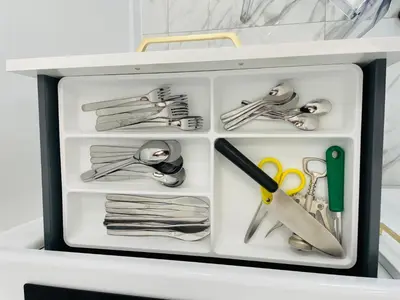a drawer with scissors and other items in it at Malborska 29 in Kraków