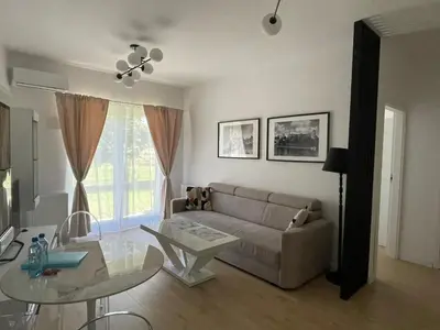 a living room with a couch and a glass table at Malborska 29 in Kraków