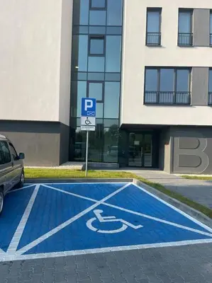 a blue handicapped parking lot in front of a building at Apartment Barrier-Free in Kraków