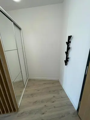 a room with a mirror and a wooden floor at Apartment Barrier-Free in Kraków