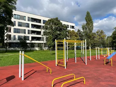 a playground with yellow equipment on a red carpet at Apartment Barrier-Free in Kraków