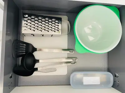 a drawer filled with kitchen utensils and a strainer at Apartment Barrier-Free in Kraków