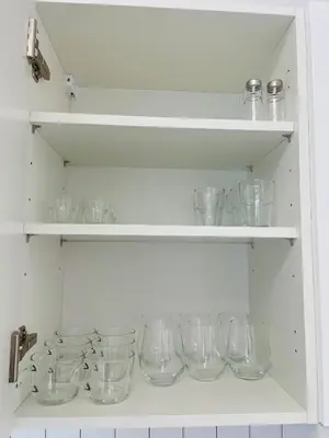 a bunch of glasses on shelves in a kitchen at Apartment Barrier-Free in Kraków