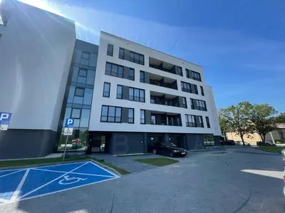 a large building with a parking lot in front of it at Apartment Barrier-Free in Kraków