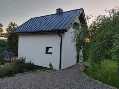a white garage with a letter e on it at Domki Na Wiosce in Stryszowa