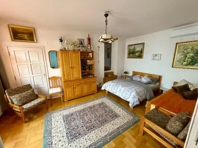 a bedroom with a bed and a chair and a table at Perfect Remote-Workplace in Sunny Apartment in Myślenice