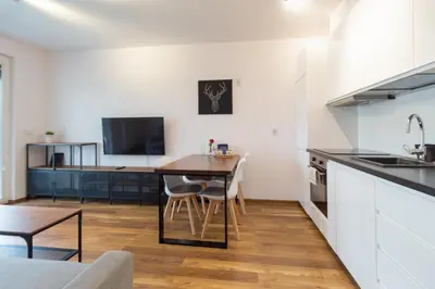 a kitchen with a table and a dining room at Zabłocie Comfort Suite in Kraków