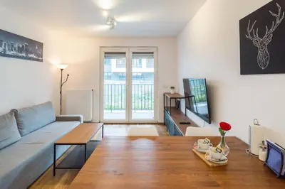 a living room with a couch and a table at Zabłocie Comfort Suite in Kraków