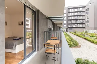 a balcony with a bedroom and a bed at Zabłocie Comfort Suite in Kraków