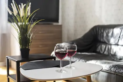 two glasses of red wine sitting on a table at Large Apartment next to Main Station - 85 m2 in Kraków