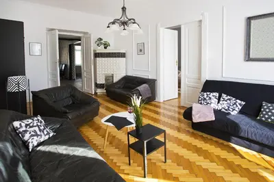 a living room with black couches and a table at Large Apartment next to Main Station - 85 m2 in Kraków