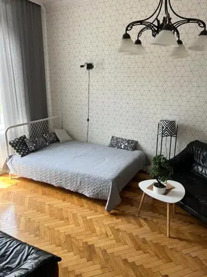 a bedroom with a bed and a table and a couch at Large Apartment next to Main Station - 85 m2 in Kraków