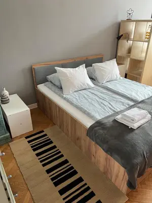 a bedroom with a bed with a blue comforter at Large Apartment next to Main Station - 85 m2 in Kraków