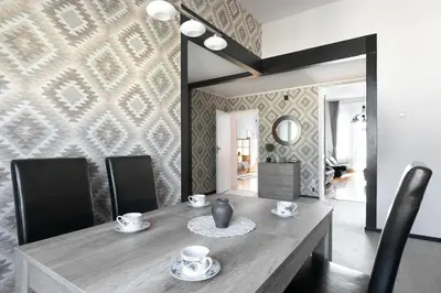 a dining room with a table with chairs and a mirror at Large Apartment next to Main Station - 85 m2 in Kraków