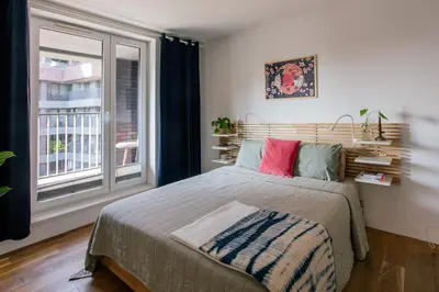 a bedroom with a large bed and a window at Nadwiślańska11 - Klimatyczny apartament tuż nad Wisłą in Kraków
