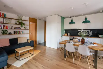a living room with a blue couch and a table at Nadwiślańska11 - Klimatyczny apartament tuż nad Wisłą in Kraków