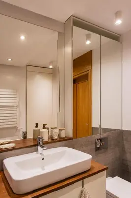 a bathroom with a white sink and a mirror at Nadwiślańska11 - Klimatyczny apartament tuż nad Wisłą in Kraków