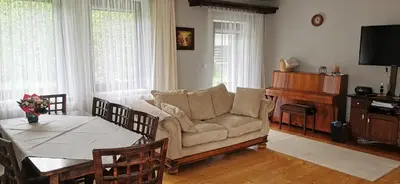 a living room with a couch and a table at Dom Gościnny Zawoja in Zawoja