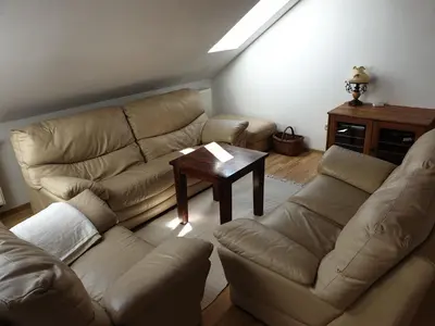 a living room with a couch and a table at Dom Gościnny Zawoja in Zawoja
