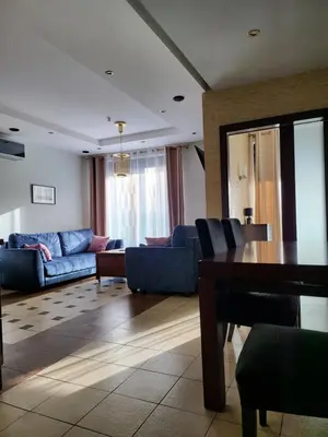 a living room with a blue couch and a table at AMBER APARTAMENt 108 in Kraków
