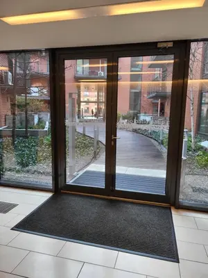 an entrance to a building with sliding glass doors at AMBER APARTAMENt 108 in Kraków