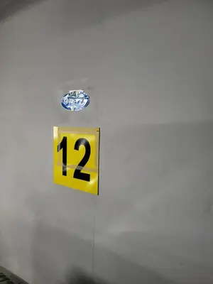 a yellow sign with the number on a wall at AMBER APARTAMENt 108 in Kraków