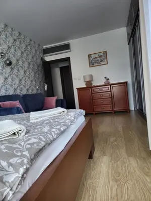 a bedroom with a bed and a dresser at AMBER APARTAMENt 108 in Kraków