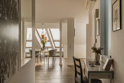 a bedroom with a large bed and a desk at Tyzenhauz Apartments Krowoderska Street in Kraków