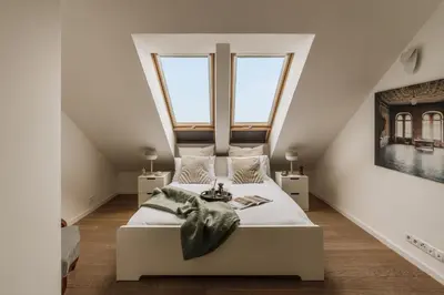 a bedroom with a large bed with a teddy bear on it at Tyzenhauz Apartments Krowoderska Street in Kraków