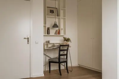a bed with a wooden headboard and white pillows at Tyzenhauz Apartments Krowoderska Street in Kraków