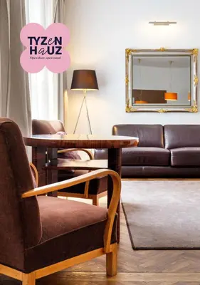 a living room with a table and chairs and a living room at Tyzenhauz Apartments Krowoderska Street in Kraków