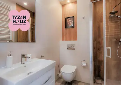 a bathroom with a sink and a toilet and a shower at Tyzenhauz Apartments Dietla Street in Kraków