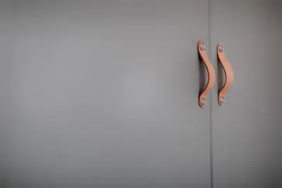 a door with two handles on a white wall at Tyzenhauz Apartments Dietla Street in Kraków