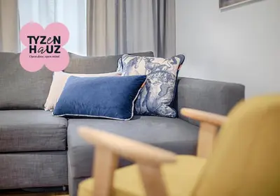 a living room with a gray couch with pillows at Central Apartments by Tyzenhauz in Kraków