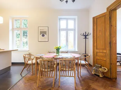 a kitchen and dining room with a table and chairs at Central Apartments by Tyzenhauz in Kraków