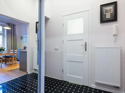 a white door in a room with a kitchen at Central Apartments by Tyzenhauz in Kraków