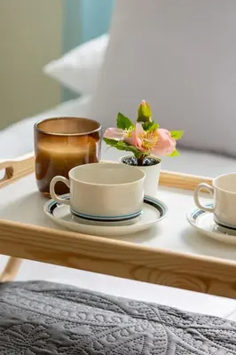a tray with three coffee cups and flowers on it at Mondrian Cracow - 2 Bedroom Apartment for Home Office by Noclegi Renters in Kraków