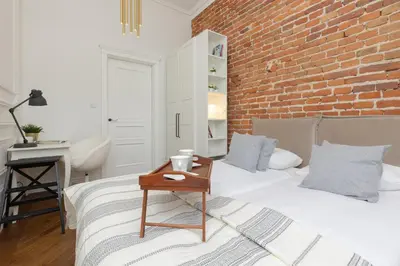 a bedroom with a bed and a brick wall at Apartment Strzelecka Old Town Cracow by Renters Prestige in Kraków