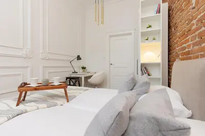 a bedroom with a bed and a brick wall at Apartment Strzelecka Old Town Cracow by Renters Prestige in Kraków