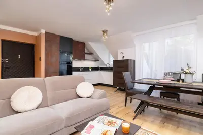 a living room with a couch and a table at The Historic Kazimierz District - Apartments with parking by Noclegi Renters in Kraków