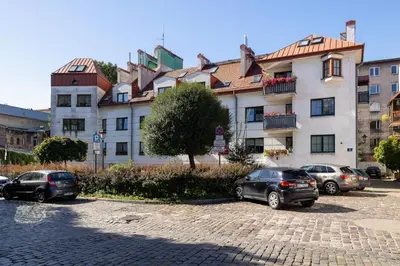 a group of cars parked in front of a building at The Historic Kazimierz District - Apartments with parking by Noclegi Renters in Kraków
