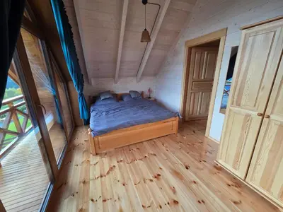 a bedroom with a bed in a tiny house at Blisko natury - chatki z sauną w Zawoi in Zawoja