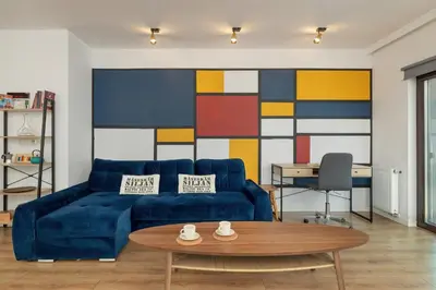a living room with a blue couch and a table at Solna Cracow Air-conditioned Apartment with Balcony by Noclegi Renters in Kraków