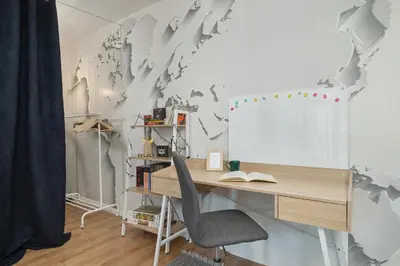 a desk with a world map on a wall at Solna Cracow Air-conditioned Apartment with Balcony by Noclegi Renters in Kraków