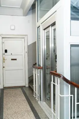 a hallway with a white door and a staircase at Cozy Old Town Studio in Kraków