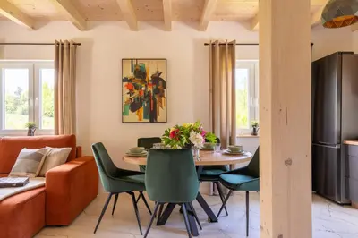 a kitchen and dining room with a table and chairs at Staymoovers - ManiaLand Domki pod Krakowem in Paszkówka