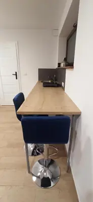 a kitchen with a wooden table and a blue chair at Kaim Hill Cracow Chillout Zone in Kraków